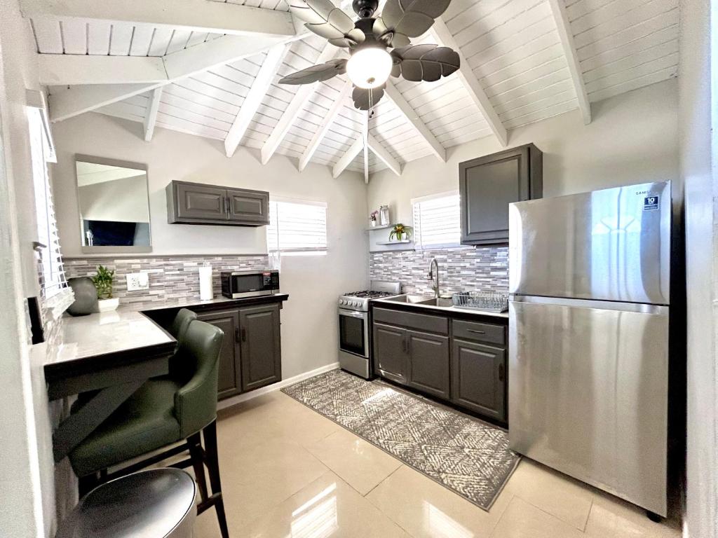 a kitchen with a refrigerator and a ceiling fan at Couples Retreat in Nazareth