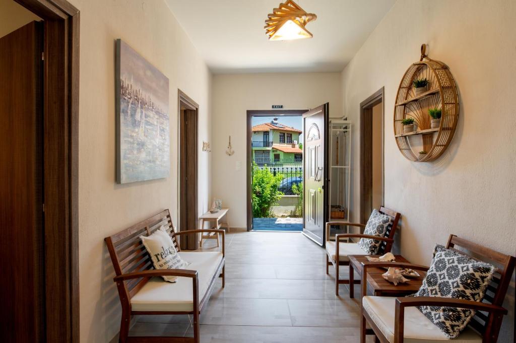 a hallway with chairs and a door to a house at Bella Garden House in Ierissos