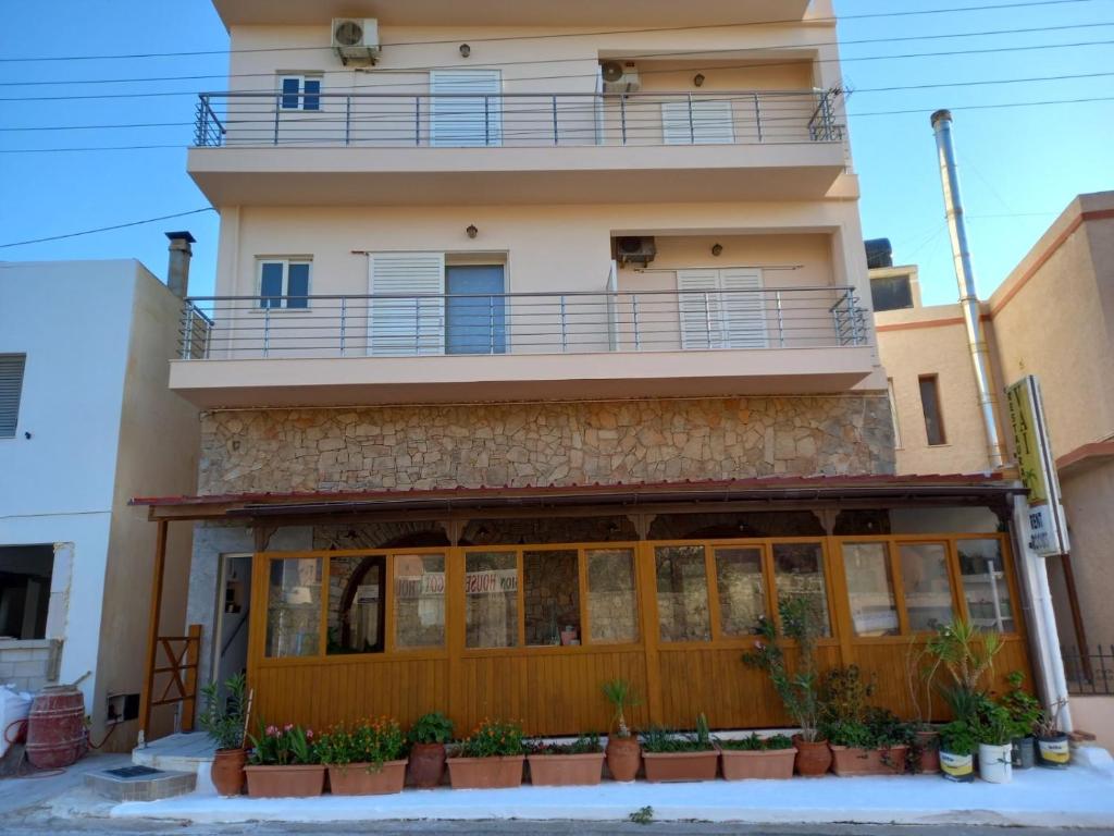 a building with a balcony on top of it at Vai Rent Rooms in Palekastron