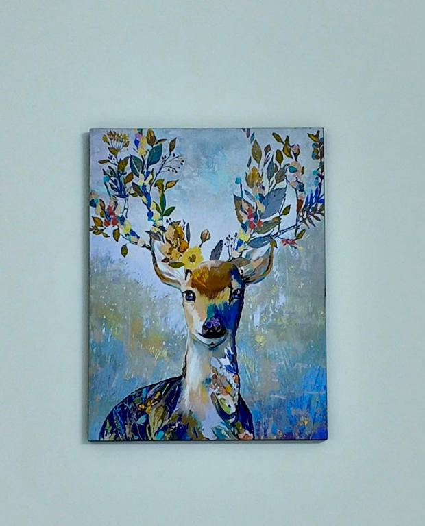 a painting of a deer with leaves on its horns at Grand Stylish Two bedrooms Apartment in El Alamein