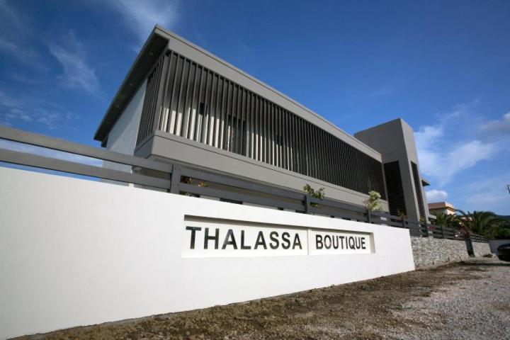 a building with a sign that reads thiasasasario building at THALASSA BOUTIQUE HOTEL in Sarti