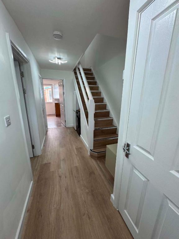 a hallway with stairs in a home with white walls at Fatjon Propeties in Drayton