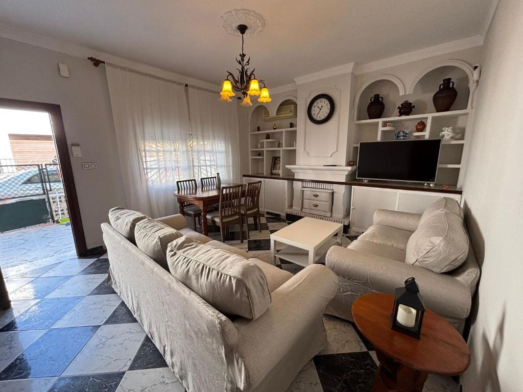 a living room with couches and a dining room at La Casuca del Chiguito in Chipiona