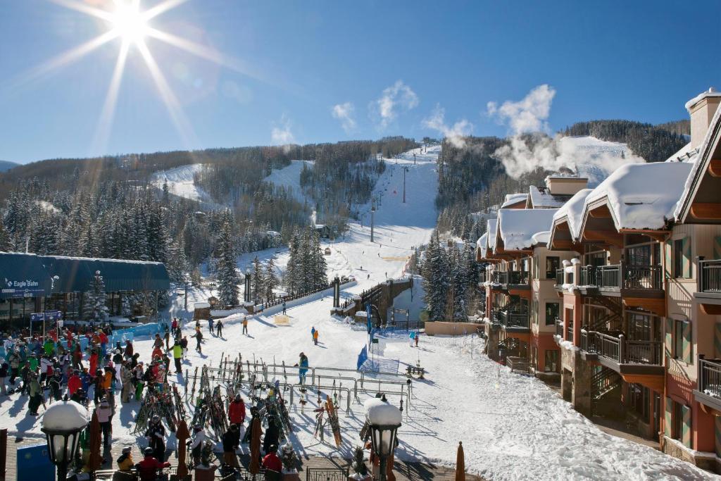 a group of people on a ski slope at a ski resort at Lion Square Lodge in Vail
