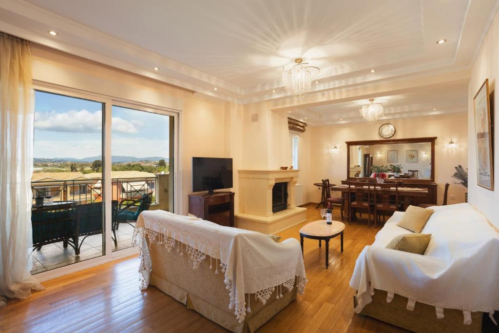 a living room with a couch and a fireplace at Maisonette ELINA in Corfu