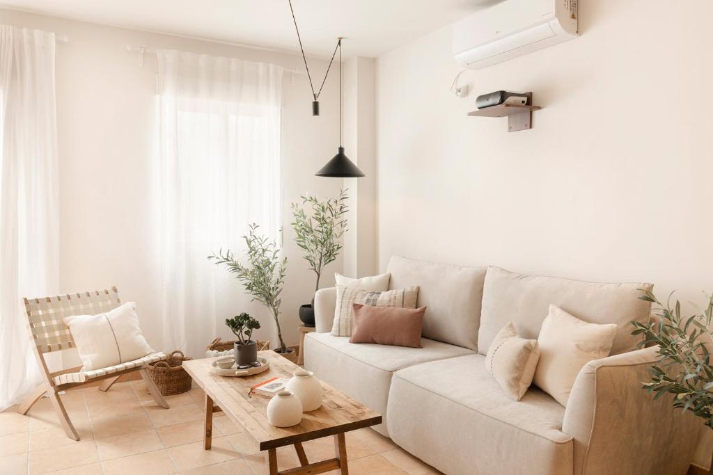 a living room with a white couch and a table at CASA CALMA Isla Tabarca - Alicante in Tabarca