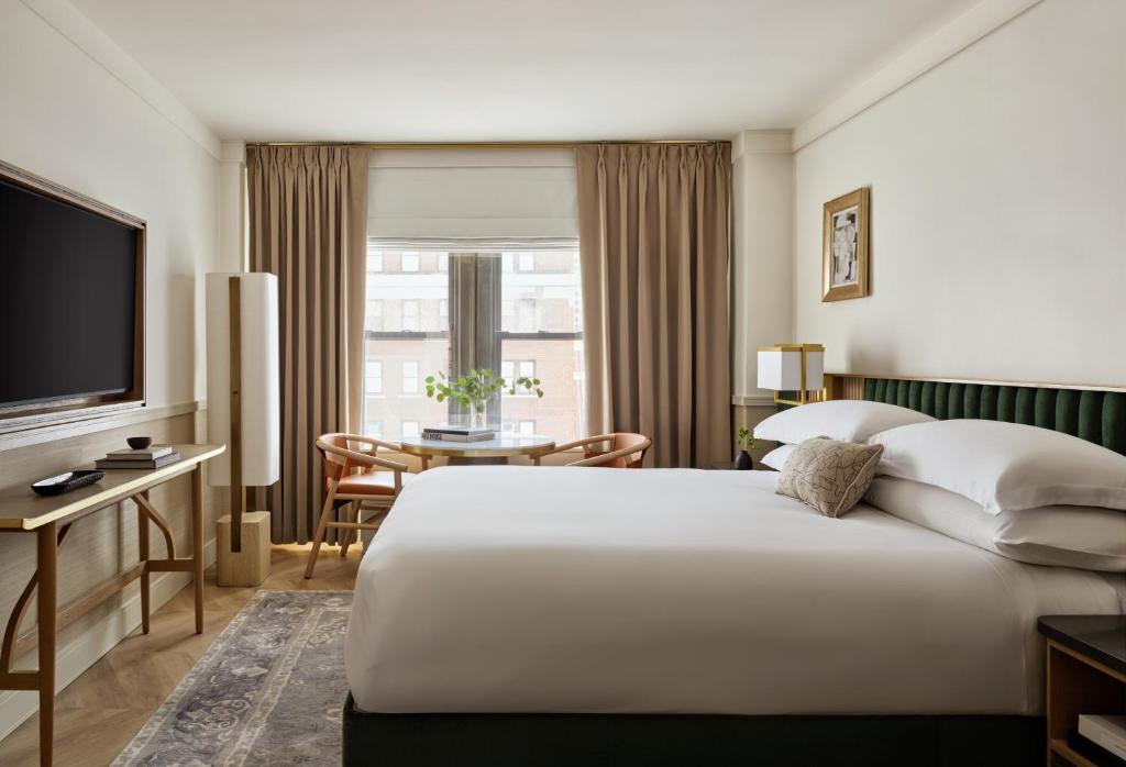 a hotel room with a large bed and a television at Kimpton Ashbel New York Park Avenue by IHG in New York