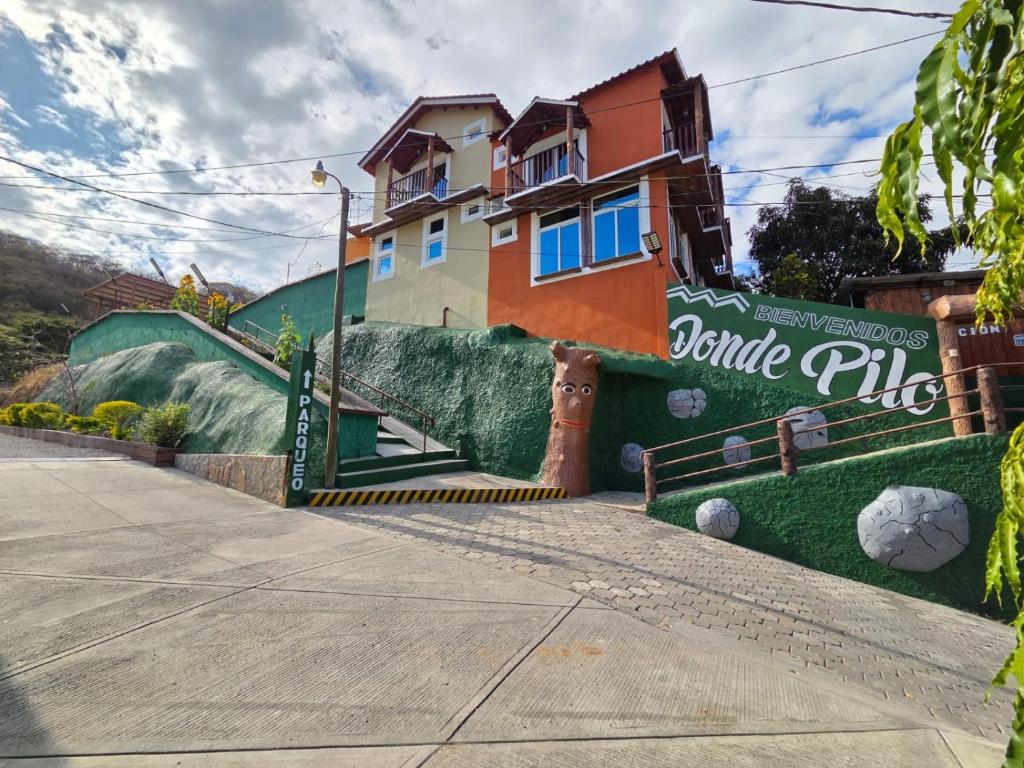 a house with a large painting on the side of it at Hotel y Restaurante Donde Pilo in Santa Rita