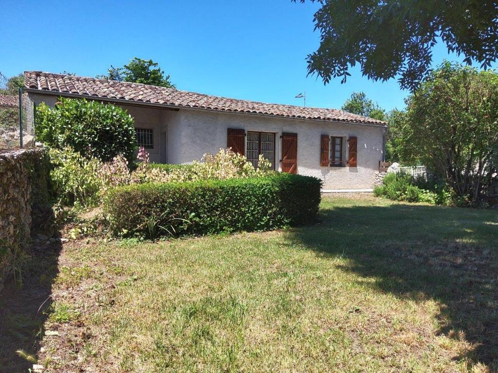 a small white house with a large yard at Gite du Fourbas in Belmont-Sainte-Foi