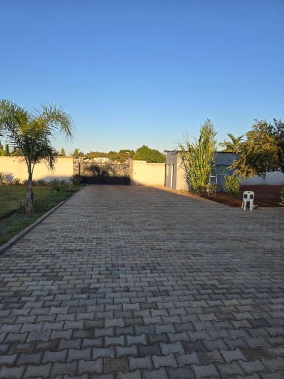 a cobblestone driveway in front of a building at Nana Kay's apartment in Livingstone