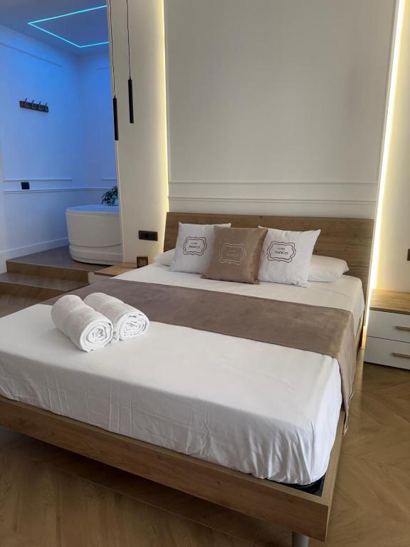 a bedroom with a bed with towels on it at La Dea Fuoco in Torre del Greco
