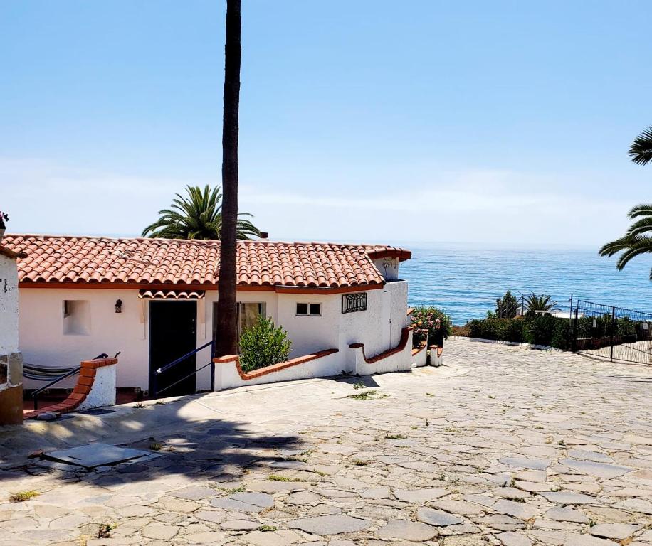a house on the beach with the ocean behind it at Ocean view house - Plaza del Mar in Rosarito