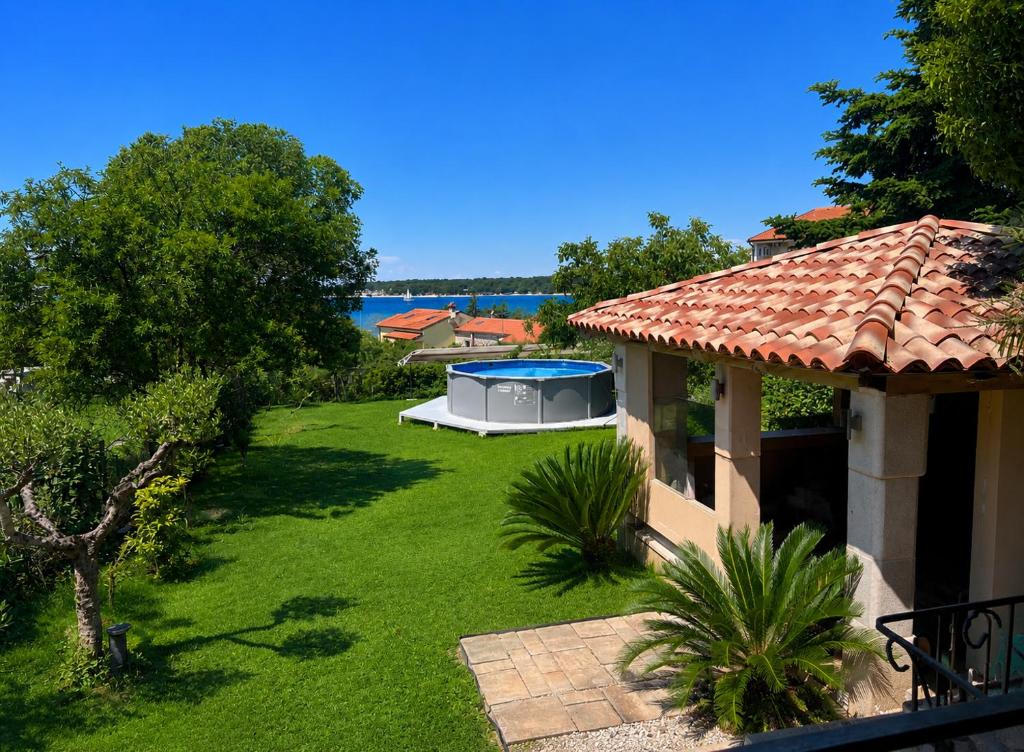 a view of a yard with a gazebo at Stone house Chiara Seaview in Funtana