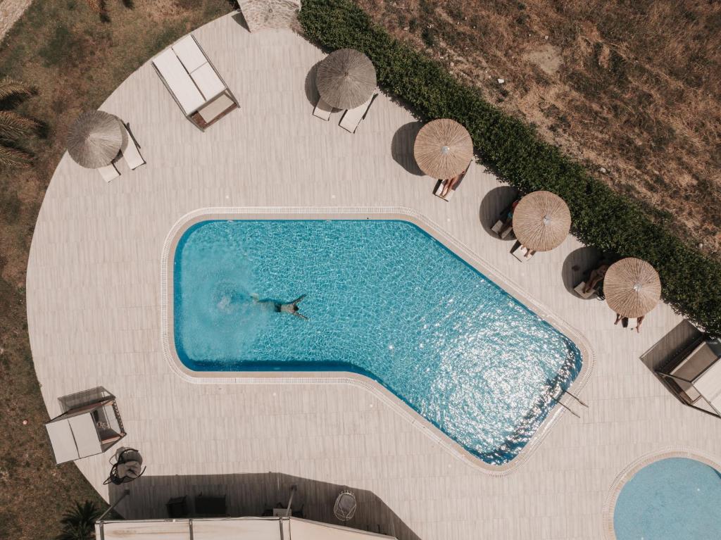 an overhead view of a swimming pool with umbrellas at Madison Boutique, Faliraki in Faliraki