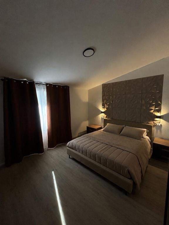 a bedroom with a large bed and a window at Laguna Blu Case Vacanza in Carbonia