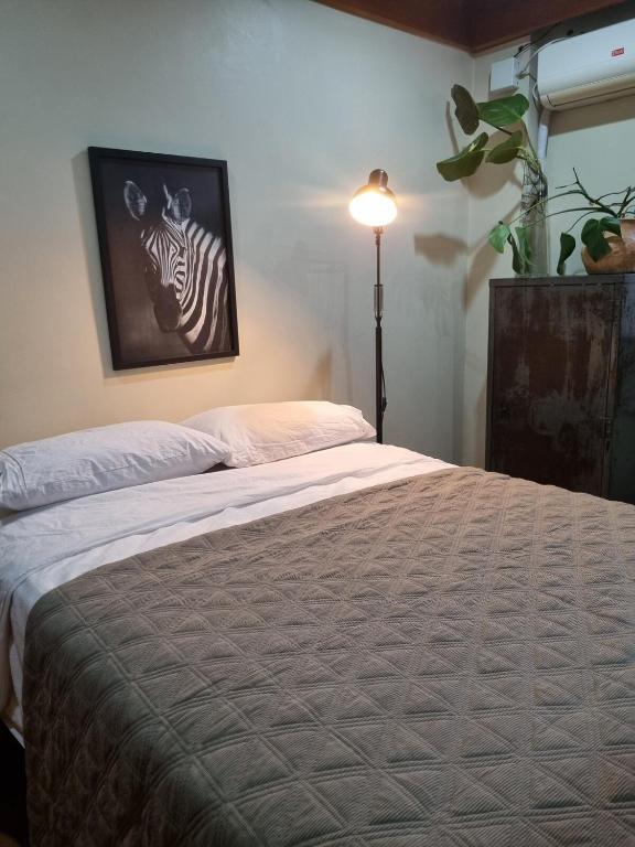 a bedroom with a bed with a zebra picture on the wall at Flora e Fauna in Porto Alegre