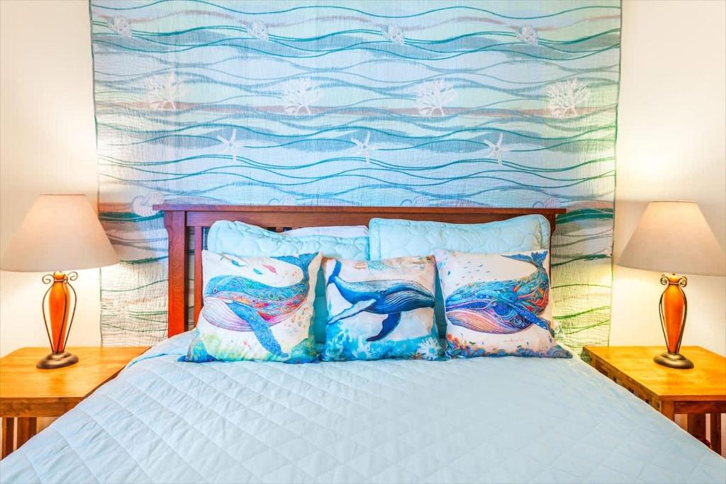 a bedroom with a bed with a painting on the wall at Hi-Tide Resort Queen Bed Unit 29 in Moclips