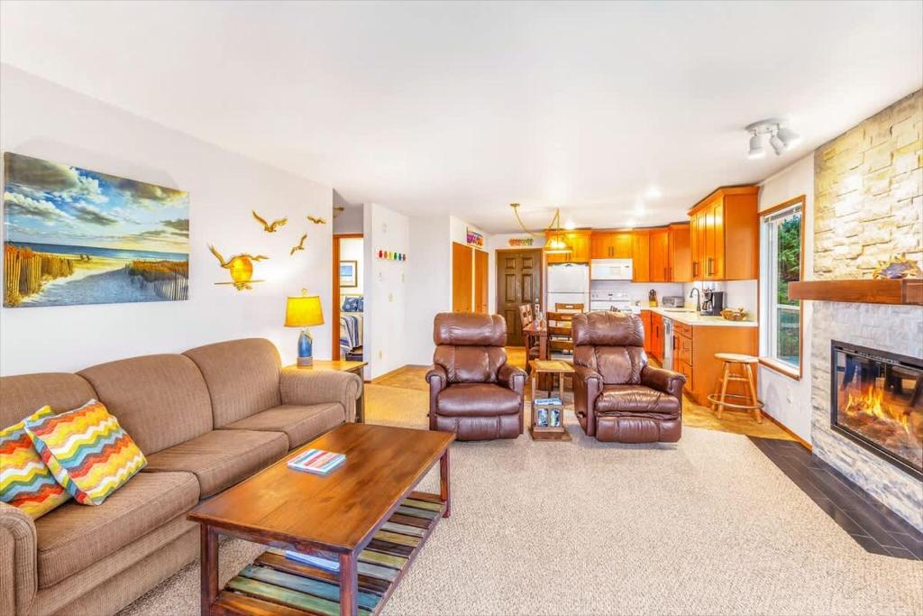 a living room with a couch and a fireplace at Hi-Tide Resort Queen Bed Unit 12 in Moclips
