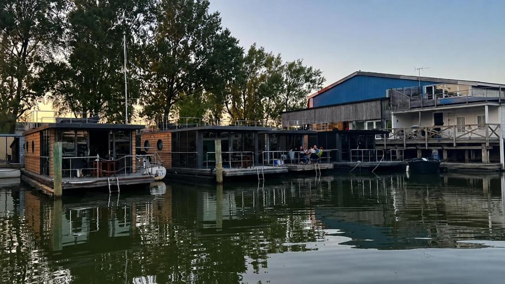 a group of buildings on the water near a body of water at La Mare Resort in Gothenburg