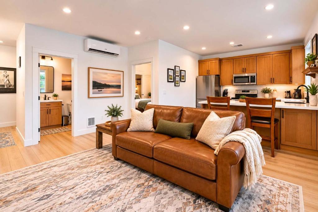 a living room with a couch and a kitchen at Modern Loft Private Golf Course Retreat in Post Falls
