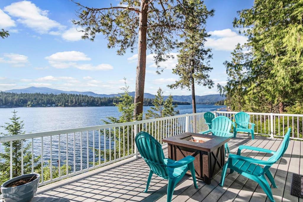 a deck with chairs and a table with a view of the water at Lakefront Cabin Dock Kayaks & Fire Pit in Hayden
