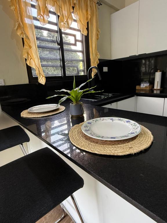 a kitchen with a black counter top with a plate on it at La casita de Polo in Polo