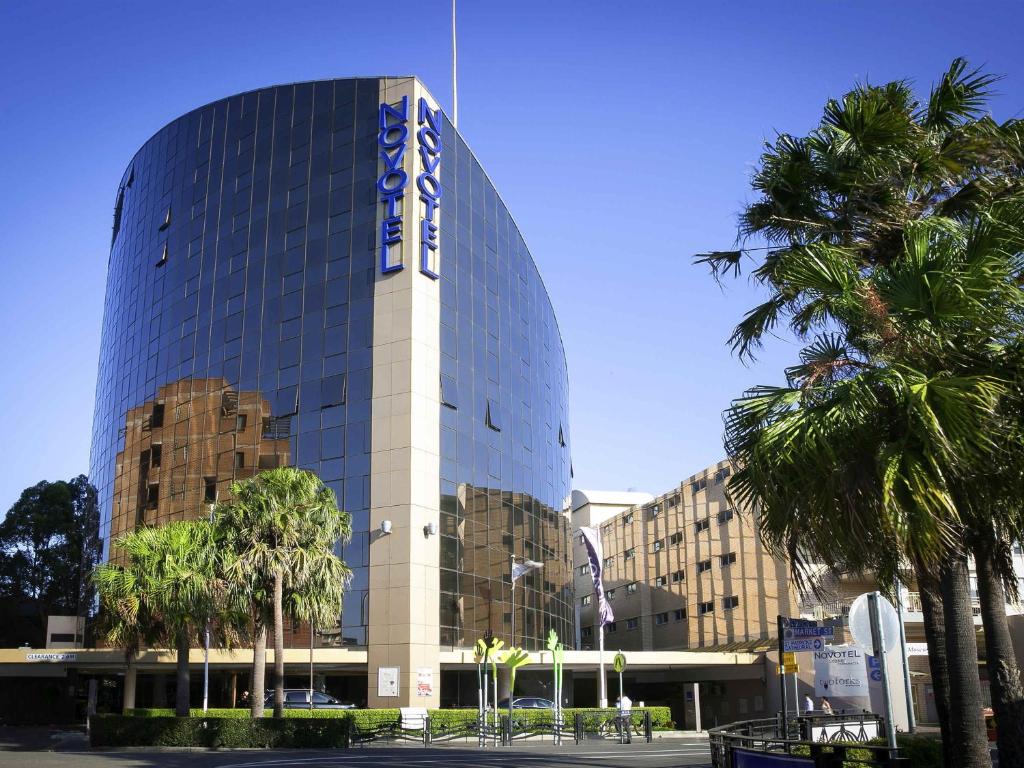 a building with a sign on the side of it at Novotel Sydney Parramatta in Sydney