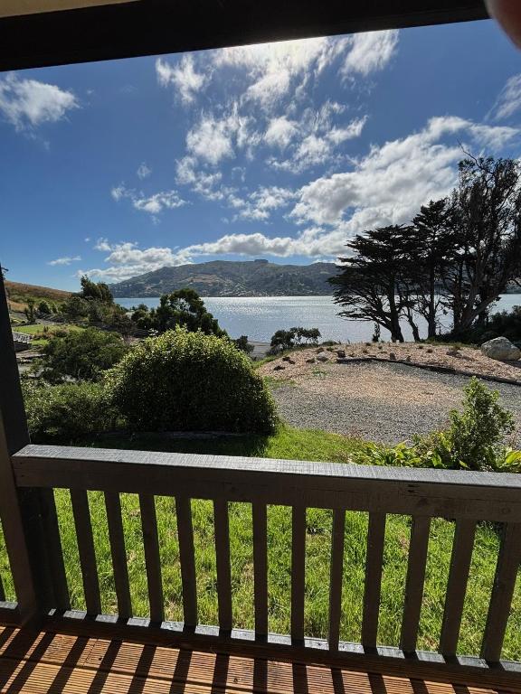 a view of the water from a porch at Raynbird Cottage in Dunedin