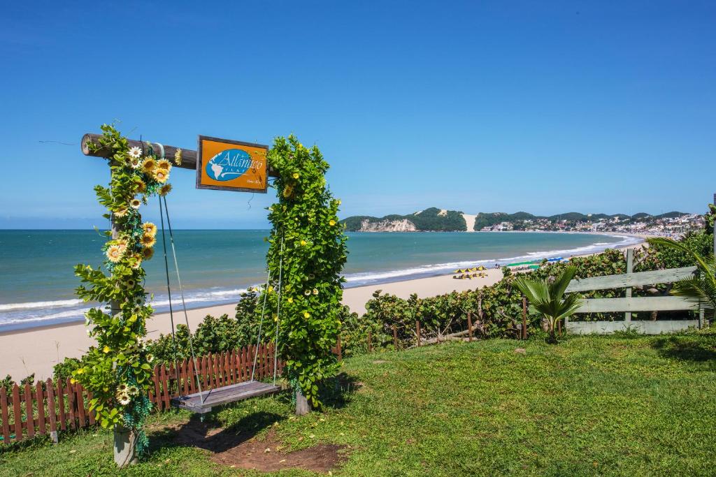 a bench on the side of a beach at Atlântico Flat Beira Mar in Natal