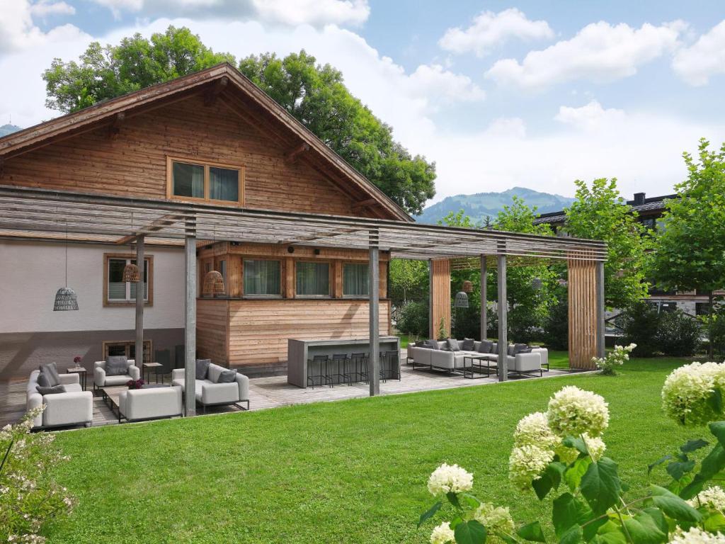 a house with a patio with couches at Stadtchalet Forsthaus in Kitzbühel