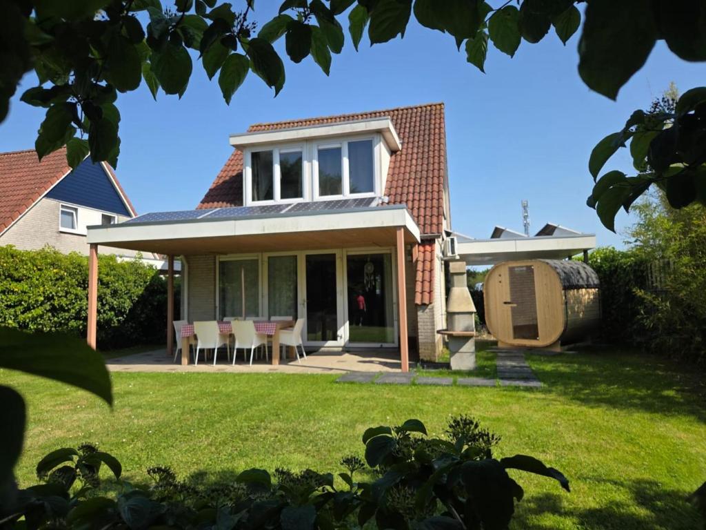 a house with a patio and a lawn at Villa Christina in Stevensweert