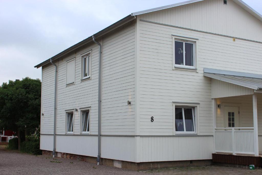a white house with windows on the side of it at Mysiga Villan in Borgholm