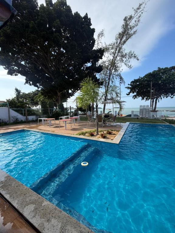 a large blue swimming pool with a frisbee in it at Maresia Beach House in Rio das Ostras