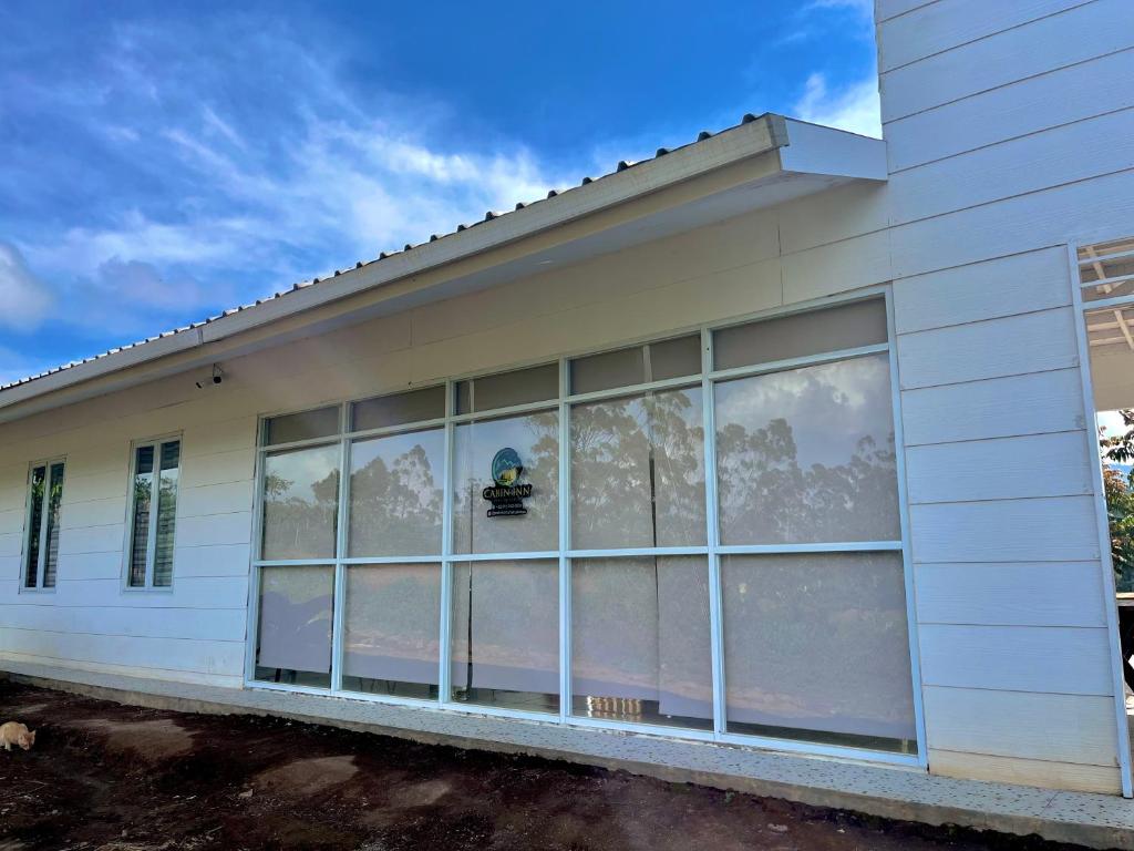a building with large windows on the side of it at Cabin Inn by Batu Pineus in Pengalongan