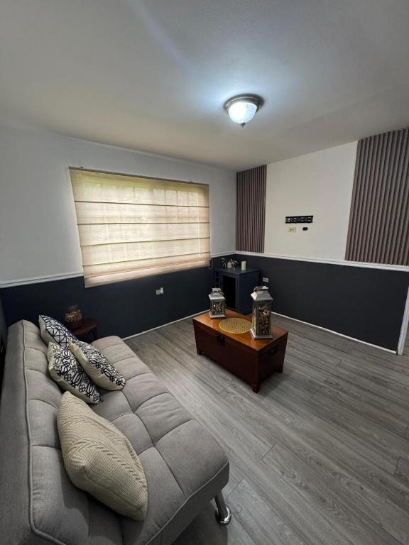 a living room with a couch and a table at Beautiful Luxe Apartment in Chitré