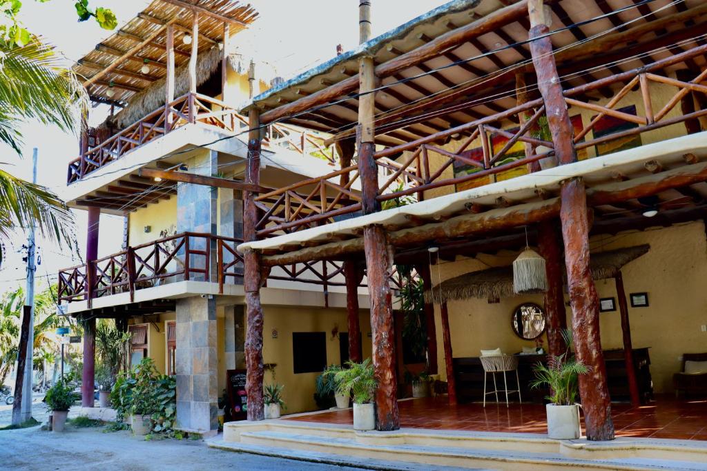 a large building with wooden beams at Chuk-Kay by ÓOL Hotels in Holbox Island