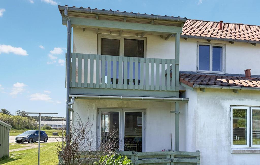 a house with a balcony on top of it at Nice Apartment In Hanstholm With Wifi in Hanstholm