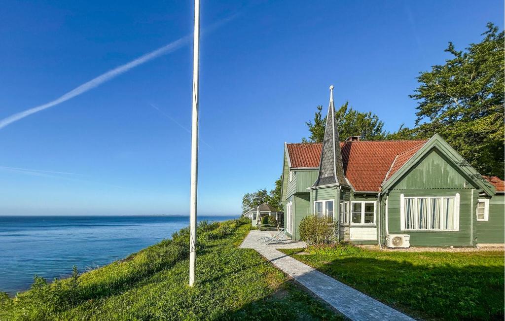 a house on a hill next to the water at Nice Home In Haderslev With Wifi in Haderslev