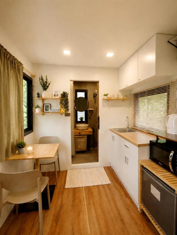 a kitchen with a table and a dining room at How Hide Homestay in Ban Tha Makham