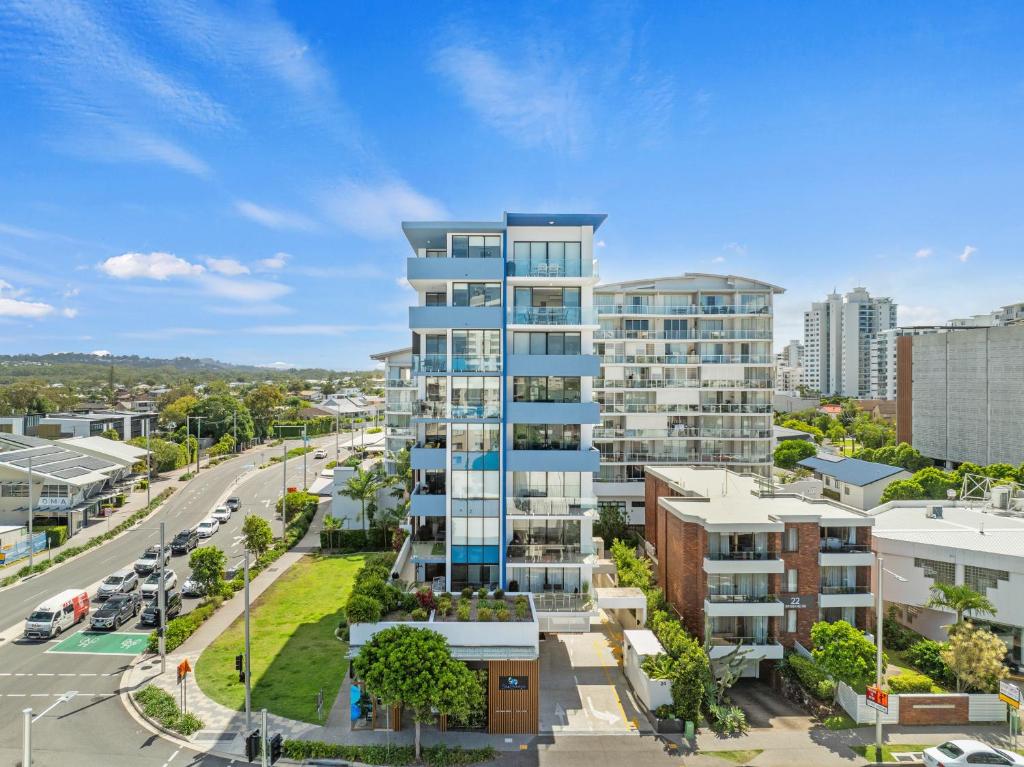 an apartment building in a city with a street at Direct Collective - Sea Breeze Mooloolaba in Mooloolaba