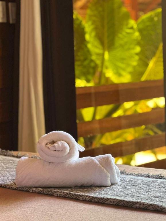 a white rolled up towel sitting on a table at Camp Olli Beach Villas in Dapa