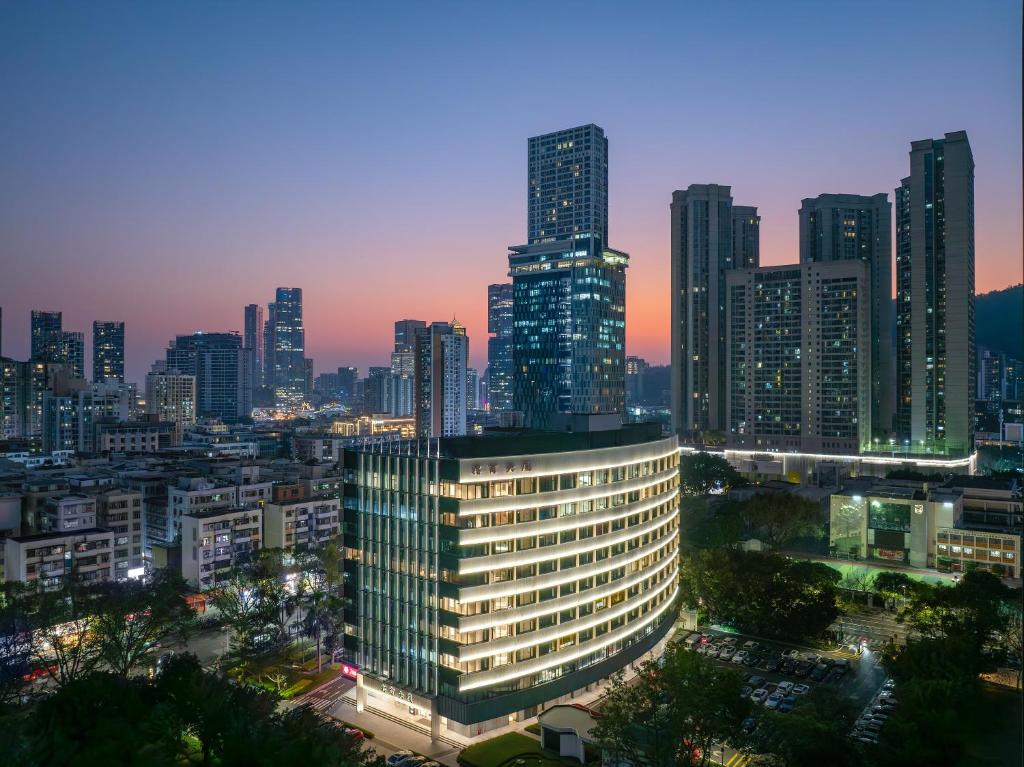 a view of a city skyline at night at SOVIS PLUS HOTEL in Shenzhen