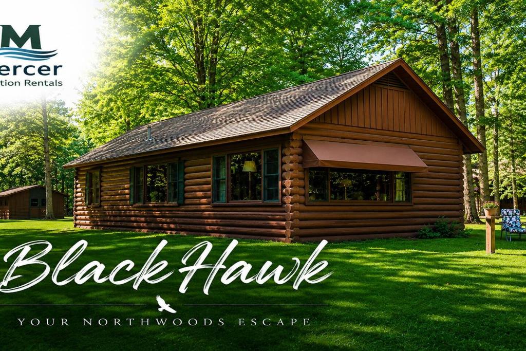 a log cabin in the grass with the words black hawk at Black Hawk in Mercer