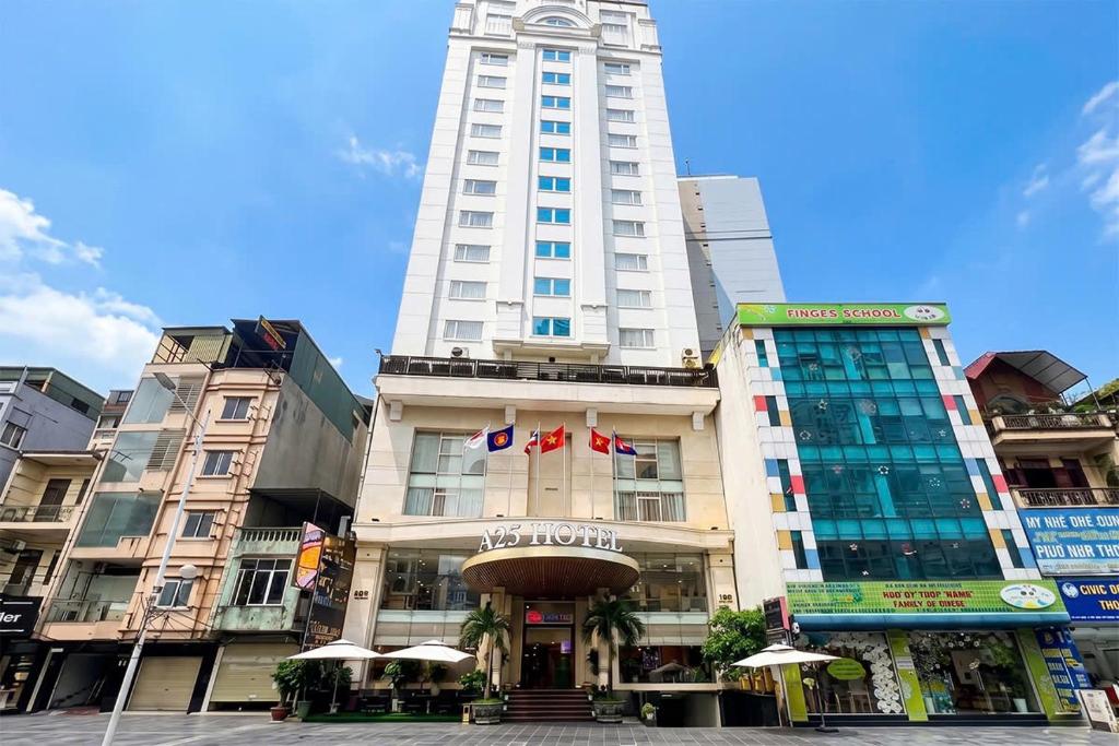 a tall white building with umbrellas in front of it at A25 Signature Hotel in Hanoi