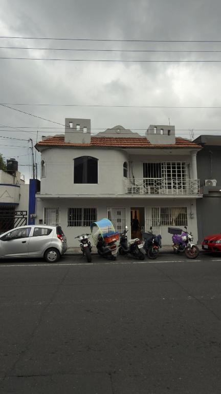 a white building with motorcycles parked in front of it at Hogar ideal in Orizaba