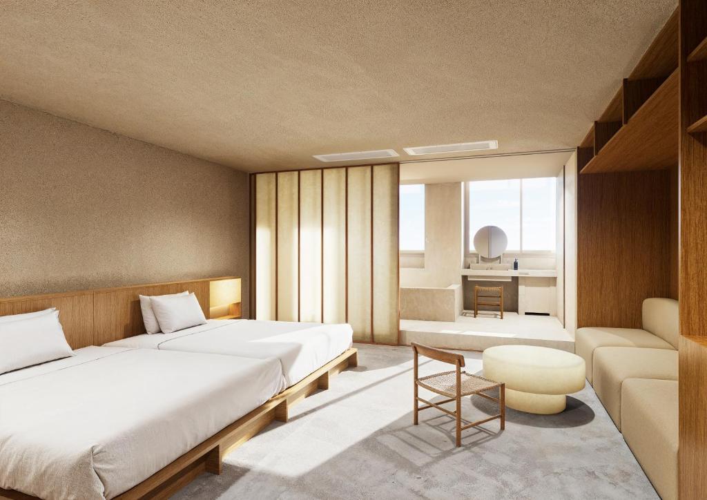 a bedroom with two beds and a couch at 島泊 島飯 島湯 in Tonosho
