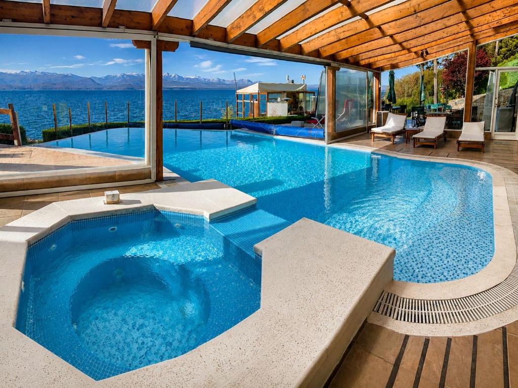 a large swimming pool with a view of the water at Sol del Nahuel - Hotel Boutique & Spa in San Carlos de Bariloche