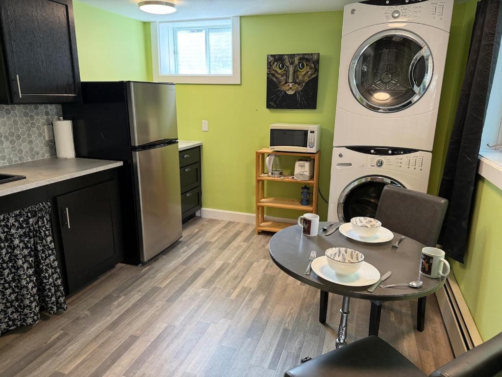 a kitchen with a table and a washing machine at Sunset Suite in Bridgewater