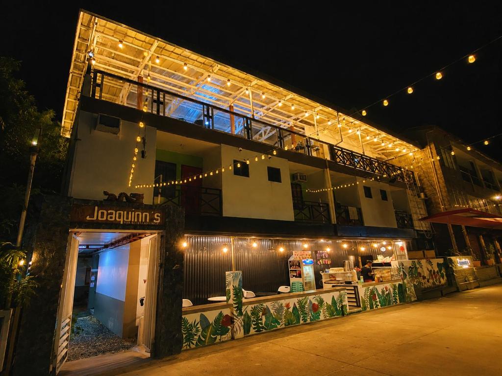 a building with lights on it at night at Joaquinn's Bed and Breakfast El Nido City near Beach in El Nido
