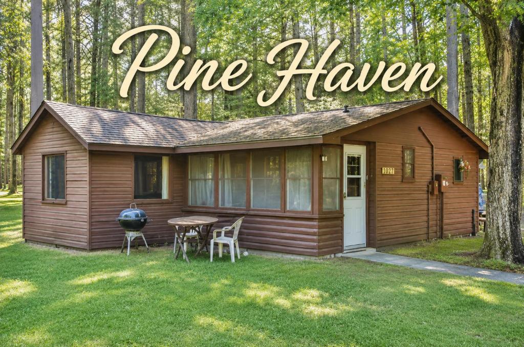 a tiny house with a table and chairs in the yard at Pine Haven in Mercer